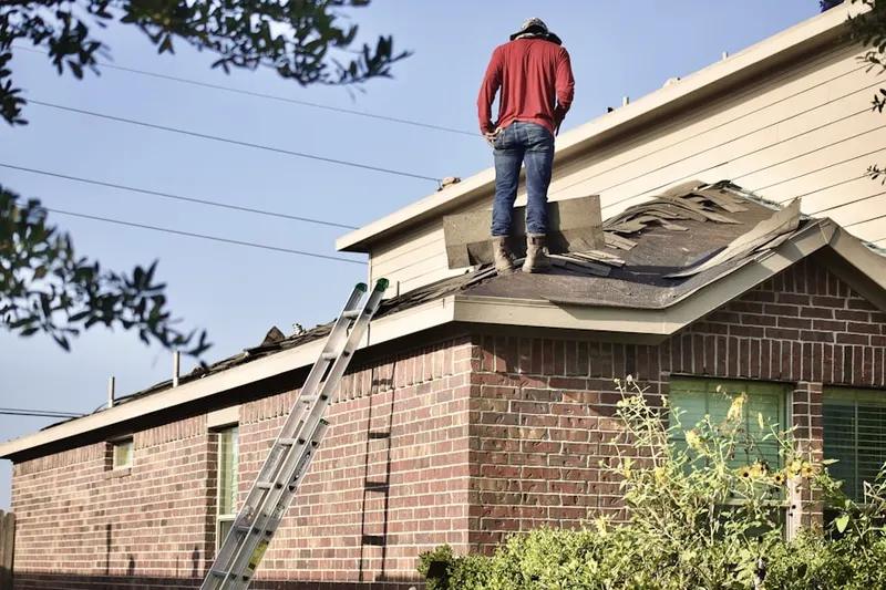 Professional roofer working on a residential roof in Ford Woods